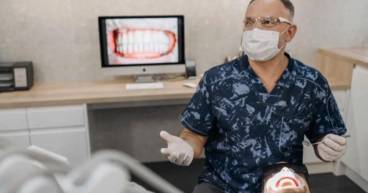 A dentist checking a patient's teeth