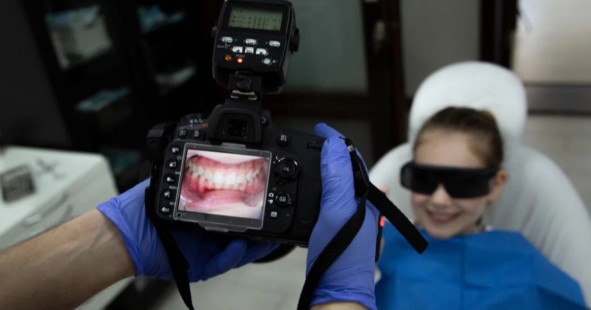 Dentist taking a clinical photograph of the teeth