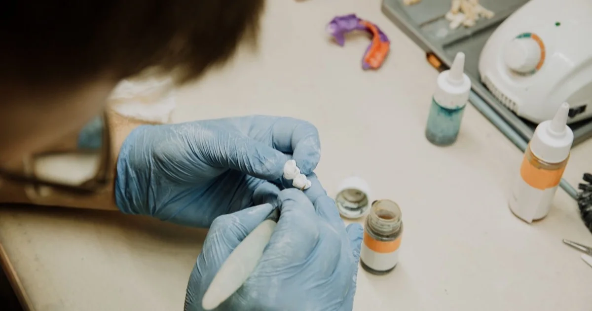 Dental technician making an implant-supported crown