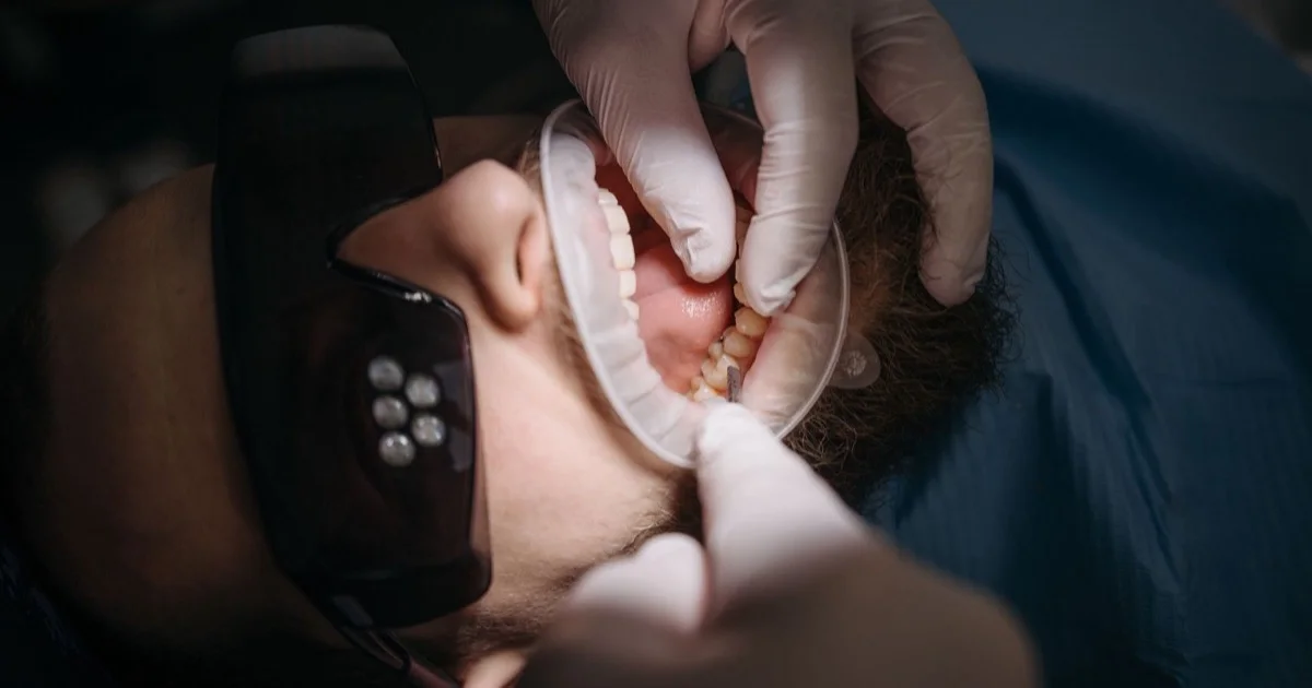 A dentist examining a patient's gums